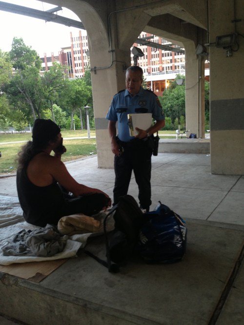 Officer Giraldo assessing needs of a homeless man.