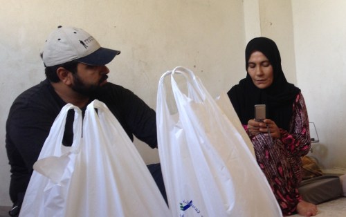 A grieving mother holding the only photo of her deceased son.
