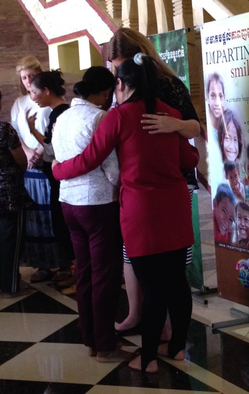 Kara Praying with Women